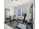 Well-equipped exercise room with natural light, a full mirror, and modern exercise machines at 15485 Sandfield Loop, Winter Garden, FL 34787