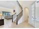 Elegant foyer features a staircase with decorative iron railings and a view into the adjacent living area at 15485 Sandfield Loop, Winter Garden, FL 34787