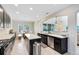 Open concept kitchen with dark cabinetry, stainless steel appliances, and an island with a white countertop at 15485 Sandfield Loop, Winter Garden, FL 34787