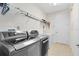 Well-organized laundry room equipped with modern washer, dryer, and ample shelving for storage at 15485 Sandfield Loop, Winter Garden, FL 34787