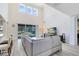 Bright living room with soaring ceilings, large windows, and a comfortable seating area at 15485 Sandfield Loop, Winter Garden, FL 34787