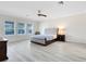 Bright main bedroom featuring neutral walls, wood-look floors, and ample natural light at 15485 Sandfield Loop, Winter Garden, FL 34787