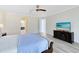 Spacious main bedroom featuring hardwood flooring, TV, and an ensuite bathroom at 15485 Sandfield Loop, Winter Garden, FL 34787