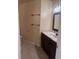 Bathroom featuring a dark wood vanity with white countertop and modern fixtures at 1621 Emily Ct, Kissimmee, FL 34744