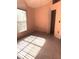 Bright bedroom with window and closet, tiled flooring, and peach color walls at 1621 Emily Ct, Kissimmee, FL 34744