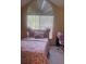 Cozy bedroom with a large window allowing natural light and neutral wall color at 1621 Emily Ct, Kissimmee, FL 34744