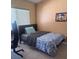 Bedroom featuring neutral wall color, large window, and tile flooring at 1621 Emily Ct, Kissimmee, FL 34744