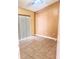 Cozy bedroom features neutral tones, tile floors, and a ceiling fan for comfortable living at 1621 Emily Ct, Kissimmee, FL 34744