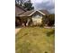 Charming home featuring a large arched window and well-maintained front yard landscaping at 1621 Emily Ct, Kissimmee, FL 34744