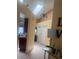 Bright hallway featuring a skylight, chandelier, tile flooring, and access to living spaces at 1621 Emily Ct, Kissimmee, FL 34744