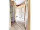 Hallway with tile floors, white doors, closet and access to other rooms at 1621 Emily Ct, Kissimmee, FL 34744