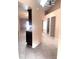 Hallway with neutral paint, tile floors, and access to bedrooms and kitchen at 1621 Emily Ct, Kissimmee, FL 34744
