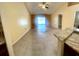 Open floor plan living room with vaulted ceilings, tile flooring and sliding glass doors at 1621 Emily Ct, Kissimmee, FL 34744