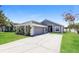 Charming single-story home with a well-manicured lawn and attached garage at 1653 Turtle Rock Dr, Lakeland, FL 33803