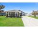 Charming single-story home with a well-manicured lawn and long driveway at 1653 Turtle Rock Dr, Lakeland, FL 33803