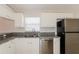 Modern kitchen with stainless steel appliances, granite countertops, and white cabinets at 1653 Turtle Rock Dr, Lakeland, FL 33803