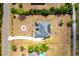 Overhead of a residence showing solar panels, a long driveway, and a circular fire pit in a spacious yard at 18920 Overton St, Orlando, FL 32833