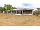 Covered back porch has screened walls, ceiling fans, and solar panels on the roof at 18920 Overton St, Orlando, FL 32833