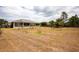 Vast backyard view showcases solar panels on the roof and mature landscaping at 18920 Overton St, Orlando, FL 32833