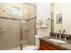 Bathroom features a glass door shower, granite countertop, and modern fixtures at 18920 Overton St, Orlando, FL 32833