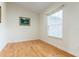 Minimalist bedroom featuring hardwood floors, a window, and a peaceful ambiance at 18920 Overton St, Orlando, FL 32833