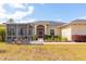 Inviting single-story home featuring a screened patio and well-maintained landscaping at 18920 Overton St, Orlando, FL 32833