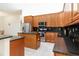 Open kitchen featuring granite countertops, stainless steel appliances, and wood cabinetry at 18920 Overton St, Orlando, FL 32833