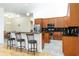 Open kitchen featuring a breakfast bar, stainless steel appliances, and granite countertops at 18920 Overton St, Orlando, FL 32833
