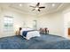 Spacious main bedroom with plush carpet, tray ceiling, and abundant natural light from the windows at 18920 Overton St, Orlando, FL 32833