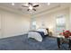 Bright main bedroom featuring plush carpet, recessed lights, and ample natural light from the windows at 18920 Overton St, Orlando, FL 32833