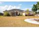 Expansive lawn surrounds the charming home with a screened lanai and paved patio area at 18920 Overton St, Orlando, FL 32833