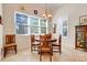 Bright dining room with a wooden table and chairs, large windows with blinds, and stylish decor, perfect for Gathering meals at 196 Torino Ln, Kissimmee, FL 34759