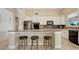 This kitchen features white cabinets, stainless steel appliances, and a breakfast bar with seating at 196 Torino Ln, Kissimmee, FL 34759