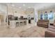 Spacious kitchen with white cabinetry, a breakfast bar, and modern appliances, seamlessly connected to the living area for easy entertaining at 196 Torino Ln, Kissimmee, FL 34759