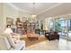 Inviting living room with a wall of bookshelves, comfortable seating, and sliding glass doors, creating a cozy and open atmosphere at 196 Torino Ln, Kissimmee, FL 34759