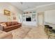 Stylish living room with built-in shelving, a comfortable sofa, and tile flooring, ideal for modern living and relaxation at 196 Torino Ln, Kissimmee, FL 34759