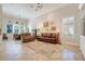 Spacious living room featuring comfortable seating, tile flooring, and large windows, providing ample natural light and a welcoming atmosphere at 196 Torino Ln, Kissimmee, FL 34759