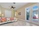 Comfortable main bedroom with a ceiling fan and outdoor access to a beautiful patio at 196 Torino Ln, Kissimmee, FL 34759
