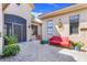 Charming outdoor patio with brick pavers, a red bench, plants, and a secure entry gate, perfect for relaxing and enjoying the fresh air at 196 Torino Ln, Kissimmee, FL 34759