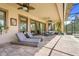 Covered patio with ceiling fans, lounge chairs, and an outdoor dining set at 196 Torino Ln, Kissimmee, FL 34759
