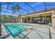 A screened-in pool with a water feature and a covered patio offers sun and shade at 196 Torino Ln, Kissimmee, FL 34759
