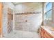 Frameless shower with tile surround, bench, and niche offers a spa-like experience with natural light at 196 Torino Ln, Kissimmee, FL 34759