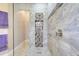 This tiled shower features a frameless glass door, a niche, and a rain shower head at 196 Torino Ln, Kissimmee, FL 34759