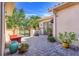 A tiled patio features outdoor seating, potted plants and a metal gate to a private courtyard at 196 Torino Ln, Kissimmee, FL 34759