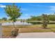 Scenic backyard view featuring a serene pond and lush landscaping under a clear blue sky at 2029 Crystal Bell St, Orlando, FL 32824