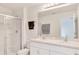 Bright bathroom featuring double sinks, a full mirror, a glass enclosed shower, and plenty of light at 2029 Crystal Bell St, Orlando, FL 32824