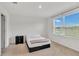 Simple bedroom features neutral carpet, a window with blinds, and a small accent table at 2029 Crystal Bell St, Orlando, FL 32824