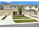 Charming townhome exterior boasts neutral colors, well-manicured lawn, and individual driveways at 2029 Crystal Bell St, Orlando, FL 32824