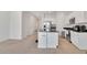 Kitchen and living area offer an open concept, island seating, and modern stainless steel appliances at 2029 Crystal Bell St, Orlando, FL 32824