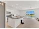 Open concept kitchen with island, stainless steel appliances, and sliding doors to a lake view at 2029 Crystal Bell St, Orlando, FL 32824